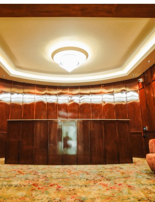 Anchorline hospitality project — wood-panelled reception with broadloom carpet